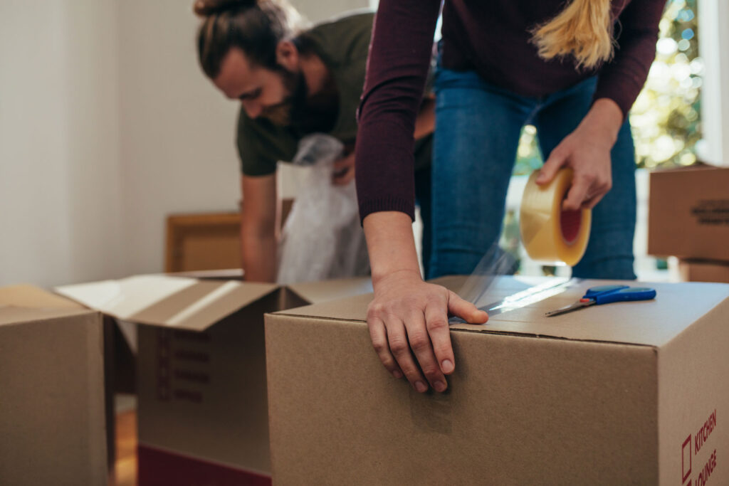 Couple packing boxes to get ready for a move.